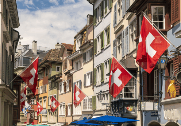 charming-old-town-street-adorned-with-swiss-flags-2025-04-05-07-24-33-utc